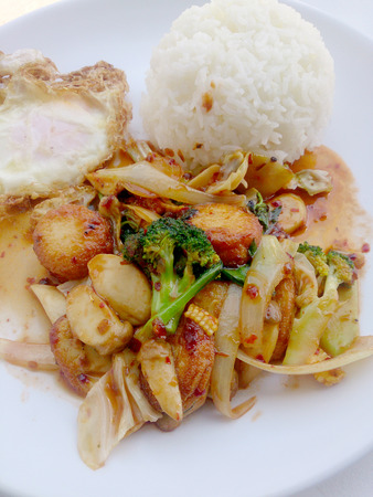 Fried tofu with mixed vegetables in white dish isolate on white background. Vegetarian Food, Healthy food.の写真素材