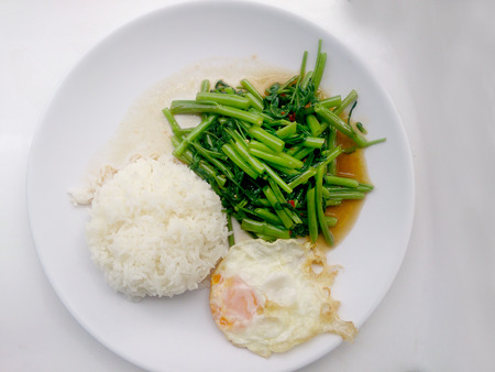 Food Thai in Asian, Stir Fried Water Spinach with rice on white plate,  Vegetarian Food, healthy foodの写真素材