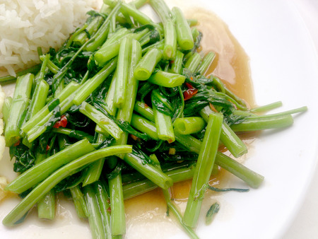 Food Thai in Asian, Stir Fried Water Spinach with rice on white plate,  Vegetarian Food, healthy foodの写真素材