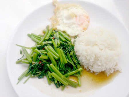 Food Thai in Asian, Stir Fried Water Spinach with rice on white plate,  Vegetarian Food, healthy foodの写真素材