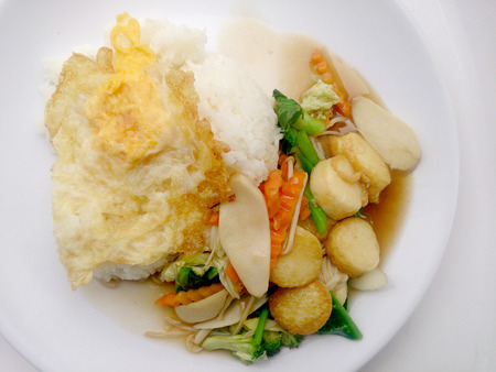Stir Fried Tofu in Chinese Style,Deep Fried Tofu with Gravy Sauce ,Stir fried tofu with  mixed vegetables in white plate on white background. Vegetarian Food, healthy food.の写真素材
