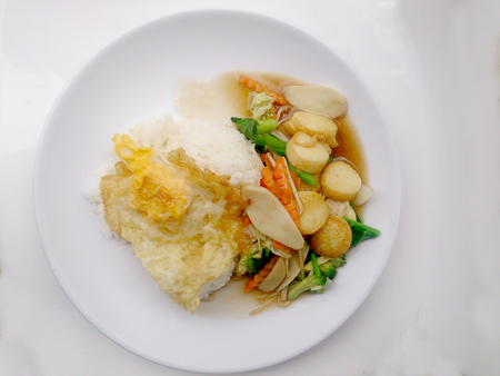 Stir Fried Tofu in Chinese Style,Deep Fried Tofu with Gravy Sauce ,Stir fried tofu with  mixed vegetables in white plate on white background. Vegetarian Food, healthy food.の写真素材
