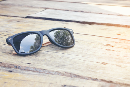 fashion sunglasses on wooden tableの写真素材