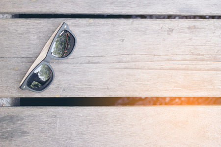 fashion sunglasses on wooden tableの写真素材
