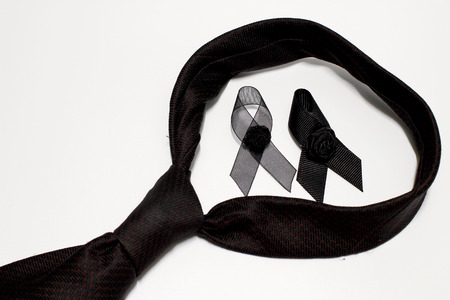 Black ribbon and black necktie; decoration black ribbon hand made artistic design for sadness expression isolated on white background.の写真素材