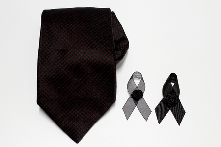 Black ribbon and black necktie; decoration black ribbon hand made artistic design for sadness expression isolated on white background.の写真素材