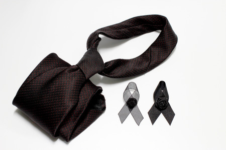 Black ribbon and black necktie; decoration black ribbon hand made artistic design for sadness expression isolated on white background.の写真素材