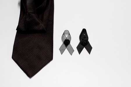 Black ribbon and black necktie; decoration black ribbon hand made artistic design for sadness expression isolated on white background.の写真素材