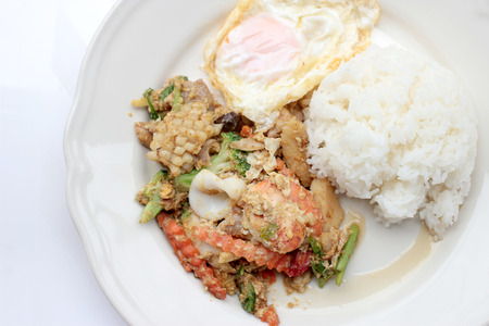 Stir-fried Soft-shelled seafood in curry powder & Thai jasmine riceの写真素材