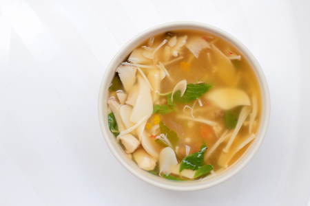 Hot and Spicy Soup with mushroom, mix vegetable and Thai herbs in white bowl on white background ,Vegetarian Food, Healthy foodの写真素材