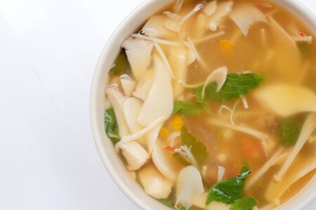 Hot and Spicy Soup with mushroom, mix vegetable and Thai herbs in white bowl on white background ,Vegetarian Food, Healthy foodの写真素材