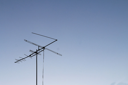 television antenna set against a blue sky.の写真素材