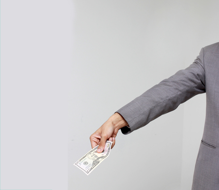 Businessman hand holding US dollar, USD. bills, offers dollar bank note money.