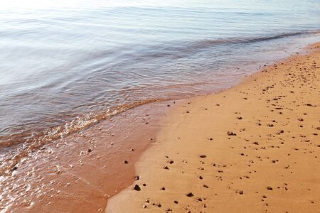 Soft wave of blue ocean on sandy beach. Background.Soft wave of blue ocean on sandy beach. Background.の写真素材