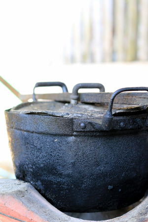 black pot and firewood for cooking in the north of thailand, old pot black colorの写真素材