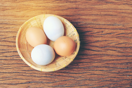 Eggs in basket with old beautiful wooden background.の写真素材