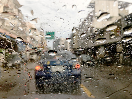 soft focus of Water drops on car glass with traffic jam background, traffic jam in Songkran Festival...