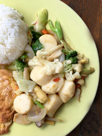 fried tofu with vegetables and Thai Omelette (scrambled eggs) in green dish on wooden table. Thai style Food. Vegetarian Food. vintage tone.の写真素材