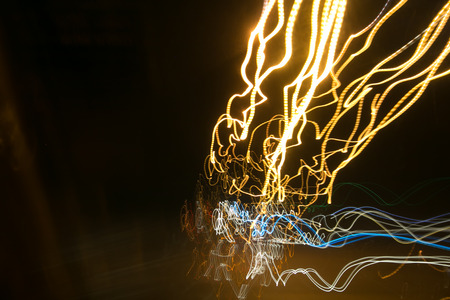 Street lights in speeding car in night time, light motion with slow speed shutter.
