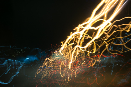 Street lights in speeding car in night time, light motion with slow speed shutter.