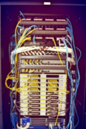 blurred image of severs computer in a rack at the large data center.