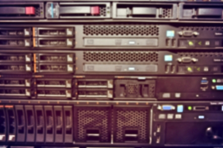 blurred image of severs computer in a rack at the large data center.
