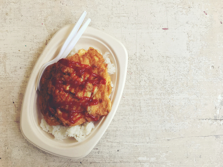 Traditional Thai omelet in paper plate on old wooden background with vintage tone colour. popular delicious food of Thailand.の写真素材