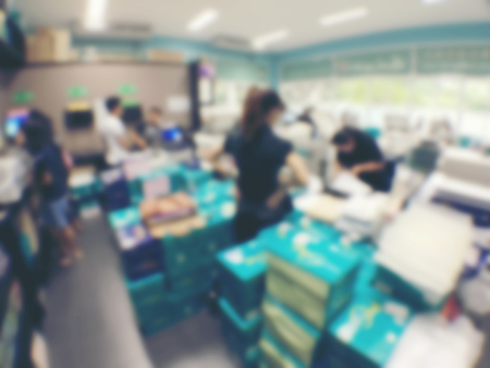 blurred image of worker is working at modern office copy documents on machine for copy, document...