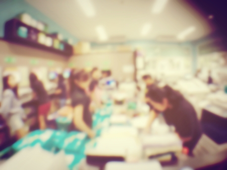 blurred image of worker is working at modern office copy documents on machine for copy, document printing and pagemaking for a book. vintage toneの写真素材