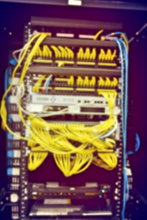 blurred image of severs computer in a rack at the large data center.