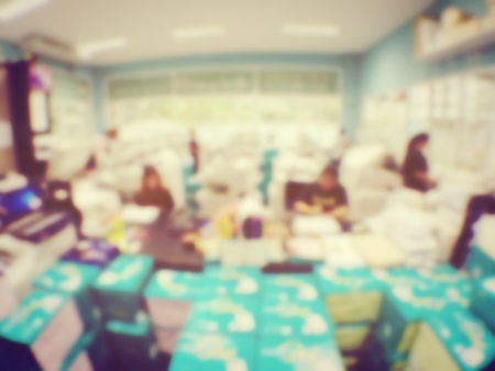 blurred image of worker is working at modern office copy documents on machine for copy, document printing and pagemaking for a book. vintage toneの写真素材