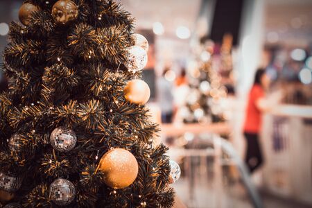 blurred image of Christmas Decorations In Christmas Tree with copy space of blur light boken and people background. vintage toneの写真素材