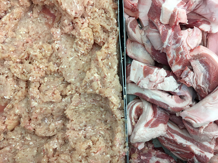 Fresh raw streaky pork belly and minced pork in plate two side at the supermarket or department. storeの写真素材