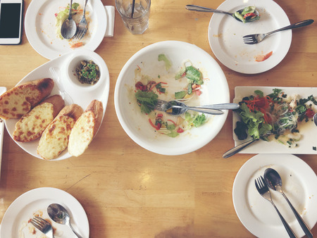 Enjoy eating. Top view of friends, family, group of people have eating healthy food together after vegetarian cooking classes while sitting at the wooden table. Group Of People Dining Conceptの写真素材