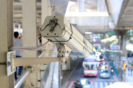 Close up of traffic security camera surveillance (CCTV) on the road to monitor the car traffic jam and security system monitoring on street road in the big city with traffic jam. vintage tone.の写真素材
