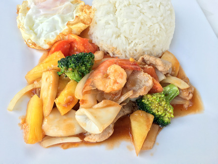 Colorful Fried Stir Sweet and sour sauce with Vegetable, shrimp and pork, a combination of fruits and vegetables in white dish on white background. Thai style food.の写真素材