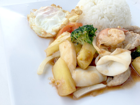 Colorful Fried Stir Sweet and sour sauce with Vegetable, shrimp and pork, a combination of fruits and vegetables in white dish on white background. Thai style food.の写真素材