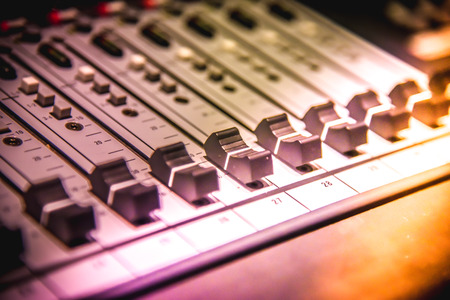 Close up of  digital sound audio mixer and amplifier equipment or music mixer equalizer console. Sound technician audio mixer equalizer control for background. studio music recording conceptの写真素材