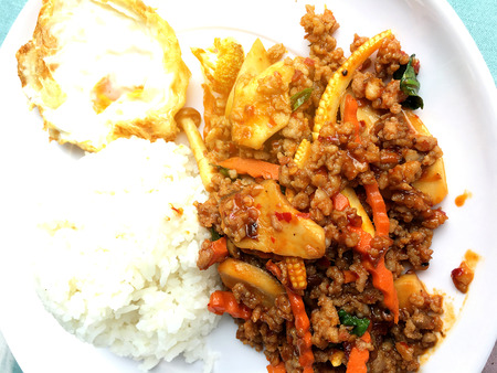 fried minced pork with tomato chili dip and vegetable in white plate with rice and fried egg and Tomato Chili Dip. Thai style food.の写真素材
