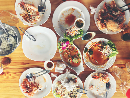 Family or friends in summer party or seafood set dinner. Flat-lay of group of mutinational people at big table eating delicious food together. Summer gathering or celebration. top view background.の写真素材