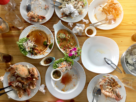 Family or friends in summer party or seafood set dinner. Flat-lay of group of mutinational people at big table eating delicious food together. Summer gathering or celebration. top view background.の写真素材