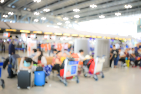 Blurred image of airport check-in counters with passengers and crowd of people control barriers with bokeh in international airport, que, travel, tourism, business concept Abstract Blur Background.の写真素材