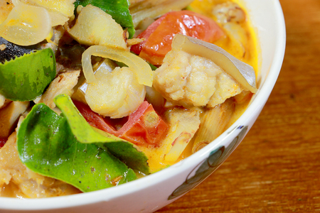 Spicy Tom Yum Soup in white blow with herb, a spicy clear soup typical in Thailand and No.1 Thai Dish Cuisine, hot and sour soup. Popular Thai Cuisine, Traditional food cuisine in Thailand,の写真素材