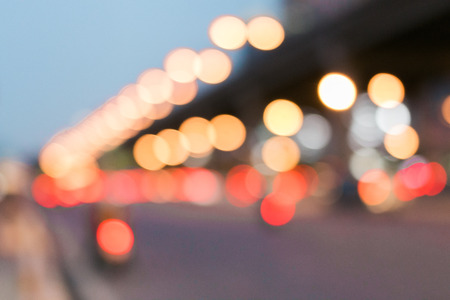 Lights or bokeh from car in the street city with modern building in midnight after raining, Abstract particles boken of light background. vintage tone filter effect.の写真素材