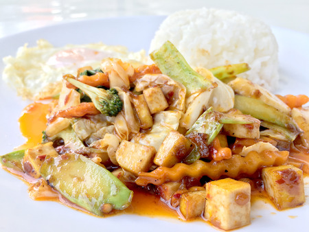 Homemade mini tofu stir fry, vegetables and chili paste with rice and fried egg in white dish on white background for celebrate Chinese new year festival. Healthy & Vegetarian  food. Thai style.の写真素材