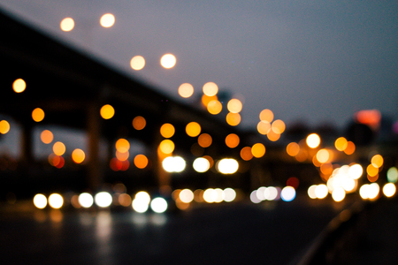 Lights or bokeh from car in the street city with modern building in midnight after raining, Abstract particles boken of light background. vintage tone filter effect.の写真素材