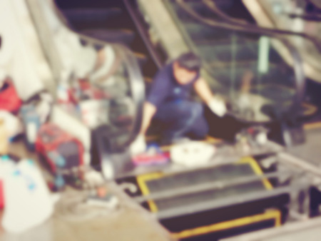 Blurred image of professional technician mechanical people assembly part of escalator. install works of indoor escalator.の写真素材