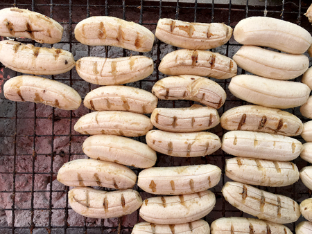 Close-up of grilled banana, Thai dessert in market, Roasting bananas on stove, Dessert by grilling banana on the hot charcoal, (Thailand traditional snacks/dessert). Street Food in Thailand, Vietnamの写真素材