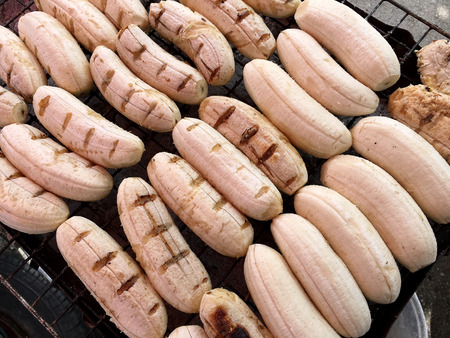 Close-up of grilled banana, Thai dessert in market, Roasting bananas on stove, Dessert by grilling banana on the hot charcoal, (Thailand traditional snacks/dessert). Street Food in Thailand, Vietnamの写真素材