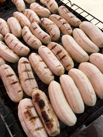 Close-up of grilled banana, Thai dessert in market, Roasting bananas on stove, Dessert by grilling banana on the hot charcoal, (Thailand traditional snacks/dessert). Street Food in Thailand, Vietnamの写真素材